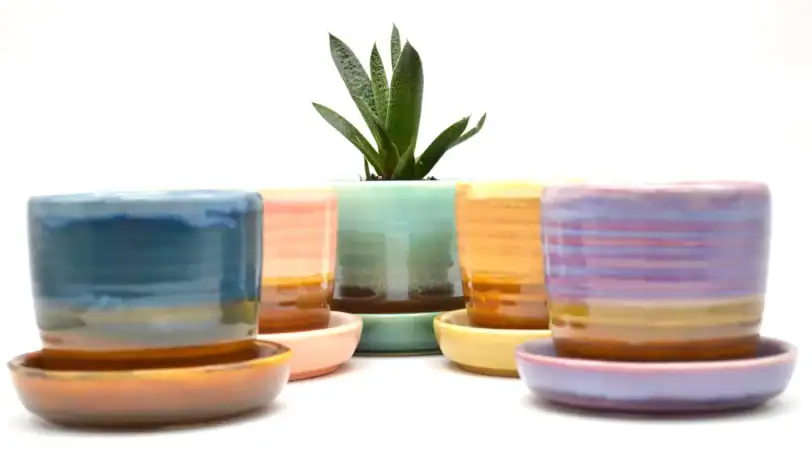 colorful ceramic travel mug with drainage and saucer